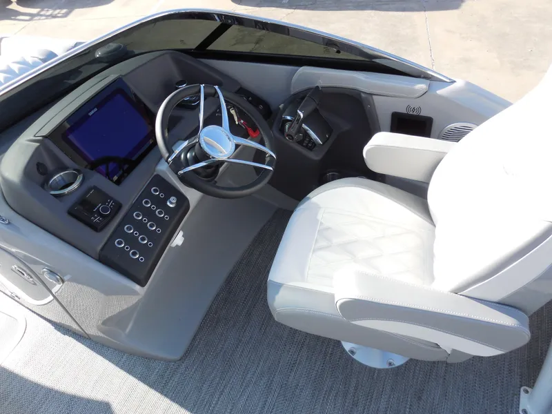Slide: The Image of 2024 Bennington 27 QXFBWAT2 boat helm with steering wheel and captain's chair. - 7