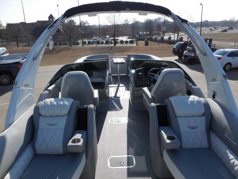 Slide: The Image of 2024 Bennington 27 QXFBWAT2 luxury pontoon boat interior with plush seating and modern dashboard. - 9