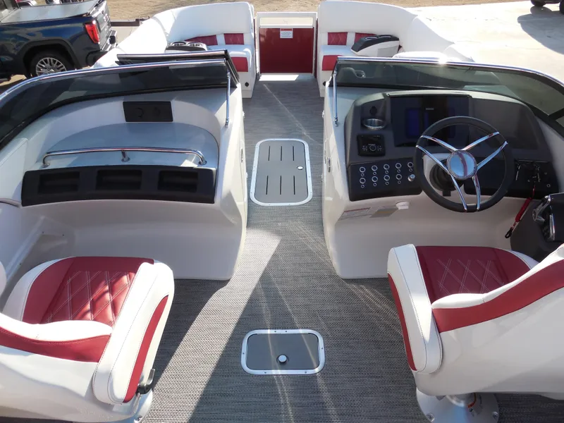 Slide: The Image of 2024 Bennington 27 QSBWAT2 boat interior with red and white seating, modern dashboard. - 11
