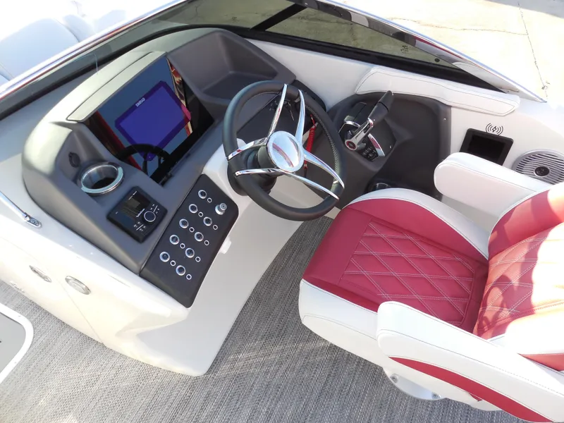 Slide: The Image of 2024 Bennington 27 QSBWAT2 boat helm with red and white captain's chair, steering wheel, and control panel. - 7