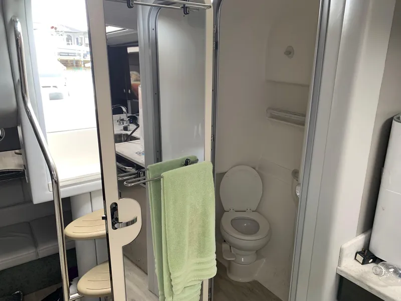 Slide: The Image of 2017 Formula 34 Cruiser bathroom with toilet, sink, and green towel. - 30