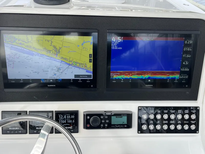 Slide: The Image of Control panel of a 2009 Jupiter 38 FS boat with navigation and sonar screens. - 15