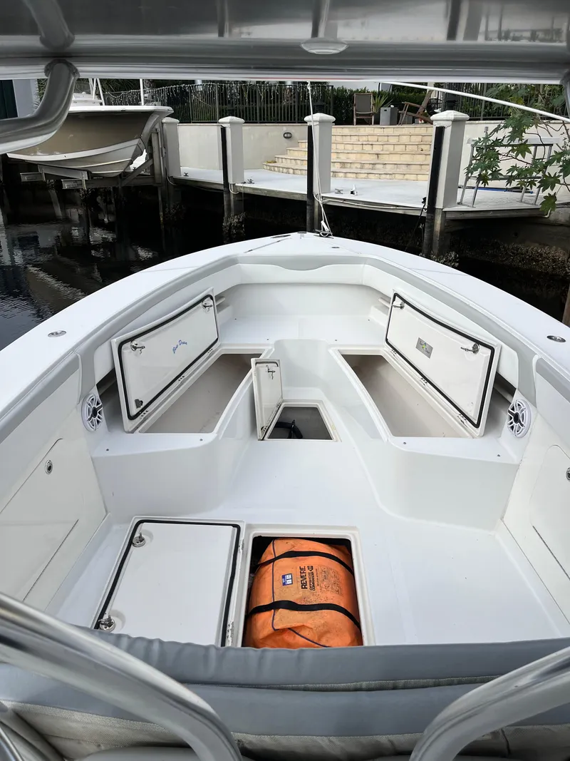Slide: The Image of 2009 Jupiter 38 FS boat with open storage compartments and an orange life jacket. - 16
