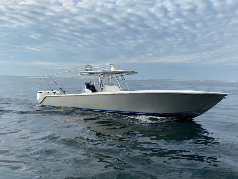 Slide: The Image of 2009 Jupiter 38 FS boat cruising on open water under a cloudy sky. - 18