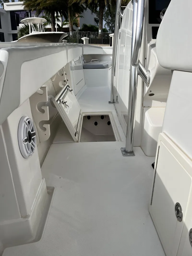 Slide: The Image of 2009 Jupiter 38 FS boat interior with storage compartments and rod holders. - 21