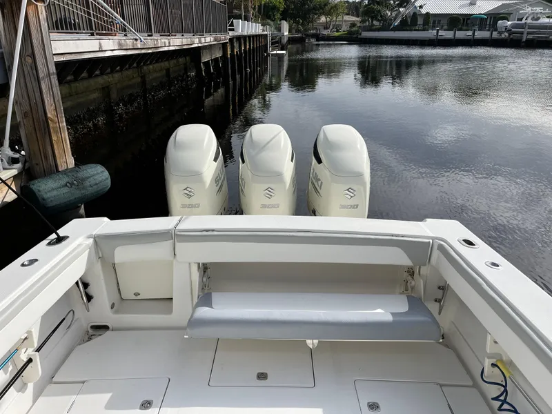 Slide: The Image of 2009 Jupiter 38 FS boat with triple outboard engines docked by the water. - 25