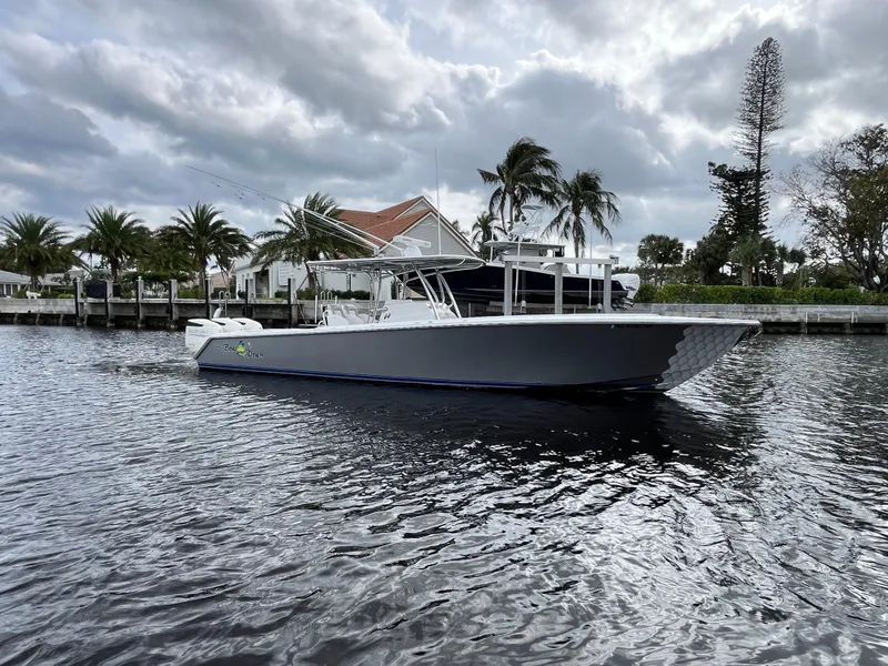 Slide: The Image of 2009 Jupiter 38 FS boat on a calm waterway with palm trees in the background. - 26