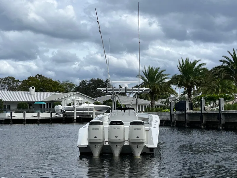 Slide: The Image of 2009 Jupiter 38 FS boat with triple 300 HP engines docked in a marina. - 27