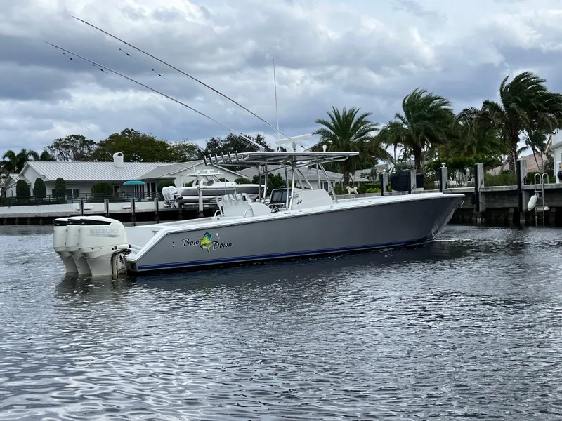 Slide: The Image of 2009 Jupiter 38 FS boat docked in a marina with palm trees in the background. - 28