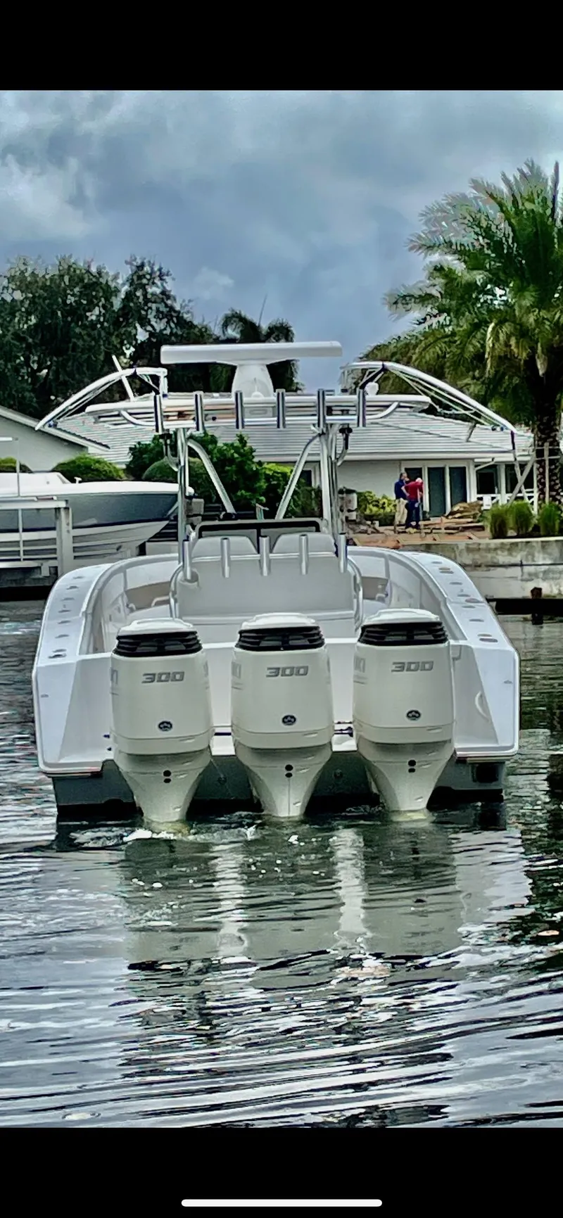 Slide: The Image of 2009 Jupiter 38 FS boat with triple 300 horsepower engines docked in a canal. - 4