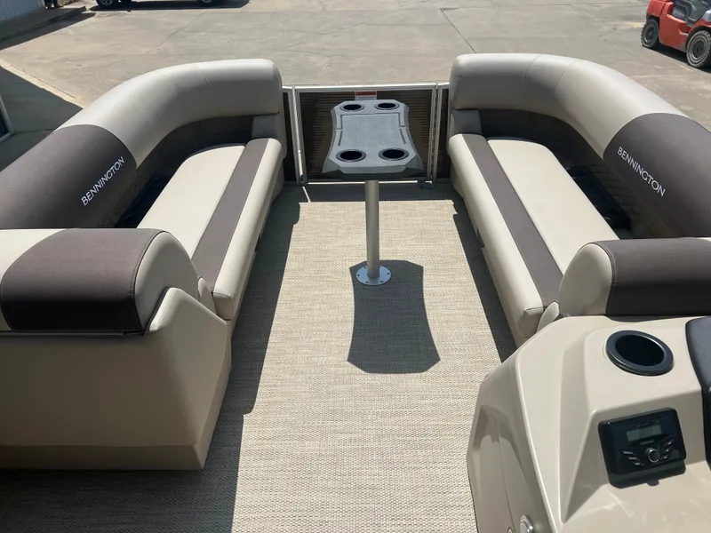 Slide: The Image of 2024 Bennington 22 SSB pontoon boat interior with beige and brown seating. - 6