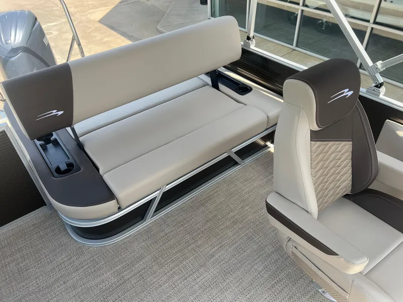 Slide: The Image of 2024 Bennington 22 SSB boat interior with beige and brown seating. - 8
