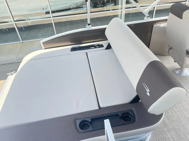 Slide: The Image of 2024 Bennington 22 SSB boat with beige and brown seating and cup holders. - 9