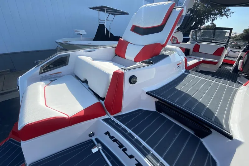 Slide: The Image of 2023 Nautique Super Air Nautique G25 Paragon interior with red and white seating. - 12