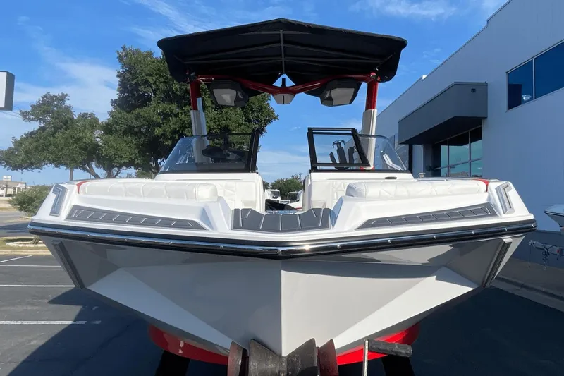 Slide: The Image of 2023 Nautique Super Air Nautique G25 Paragon boat, front view, docked outdoors. - 2