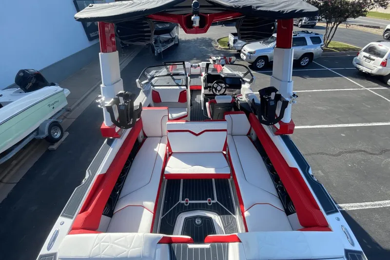 Slide: The Image of 2023 Nautique Super Air Nautique G25 Paragon interior with red and white seating. - 9
