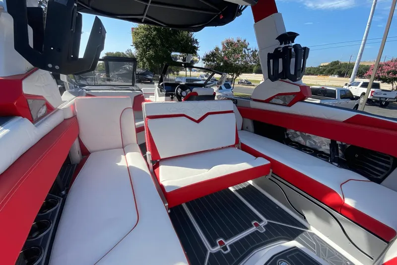 Slide: The Image of Interior of 2023 Nautique Super Air Nautique G25 Paragon boat with red and white seating. - 17