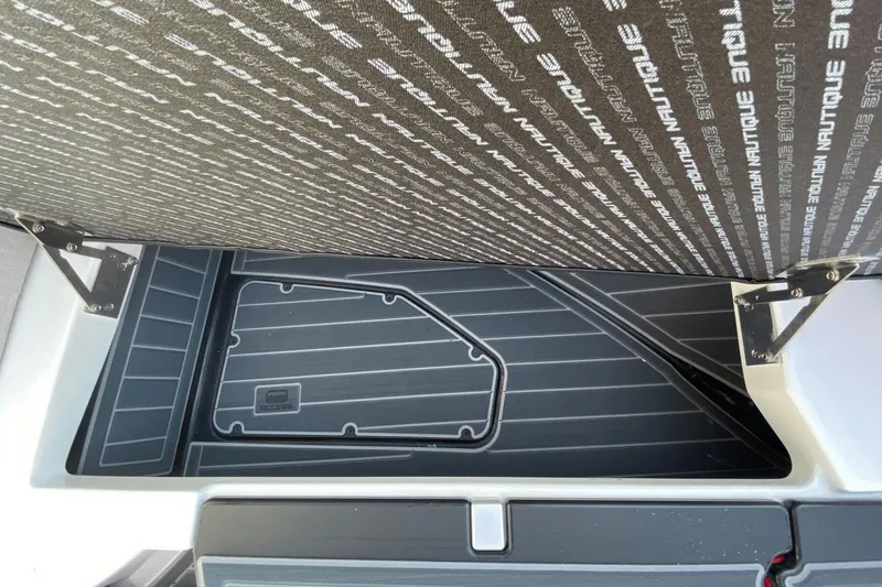 Slide: The Image of 2023 Nautique Super Air Nautique G25 Paragon storage compartment with branded cover. - 30