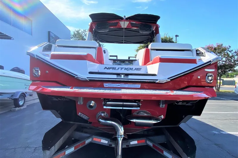 Slide: The Image of 2023 Nautique Super Air Nautique G25 Paragon boat rear view in red and white. - 5