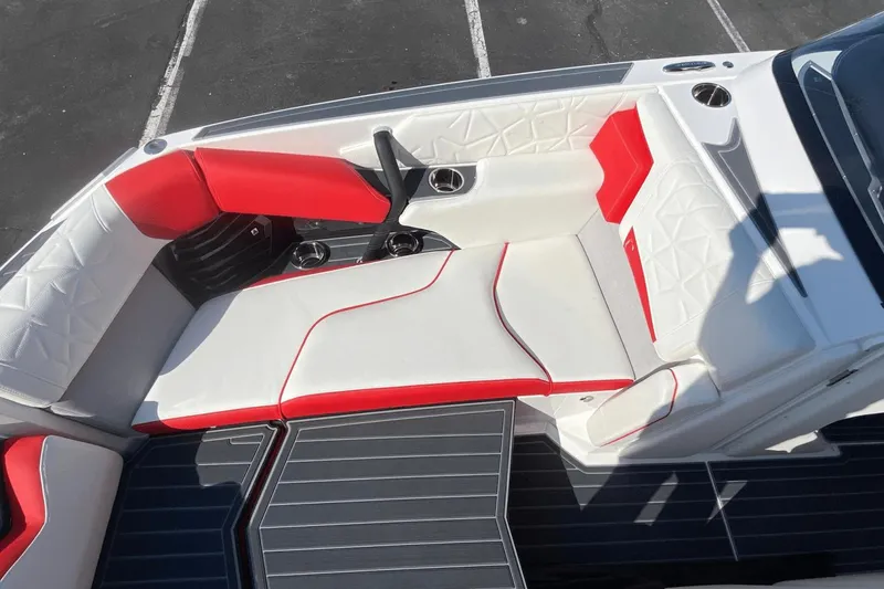 Slide: The Image of 2023 Nautique Super Air Nautique G25 Paragon boat interior with red and white seating. - 28
