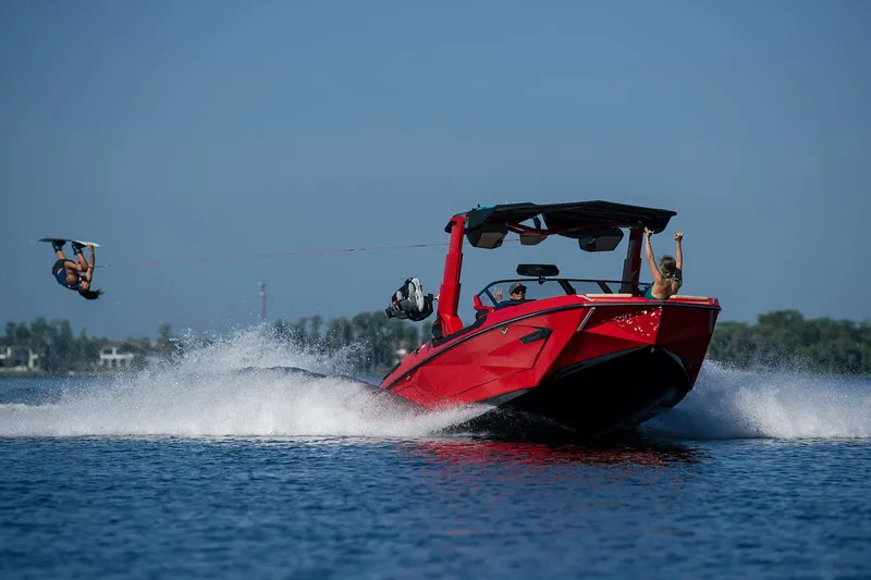 Slide: The Image of 2023 Nautique Super Air Nautique G25 Paragon towing a wakeboarder performing a flip. - 39