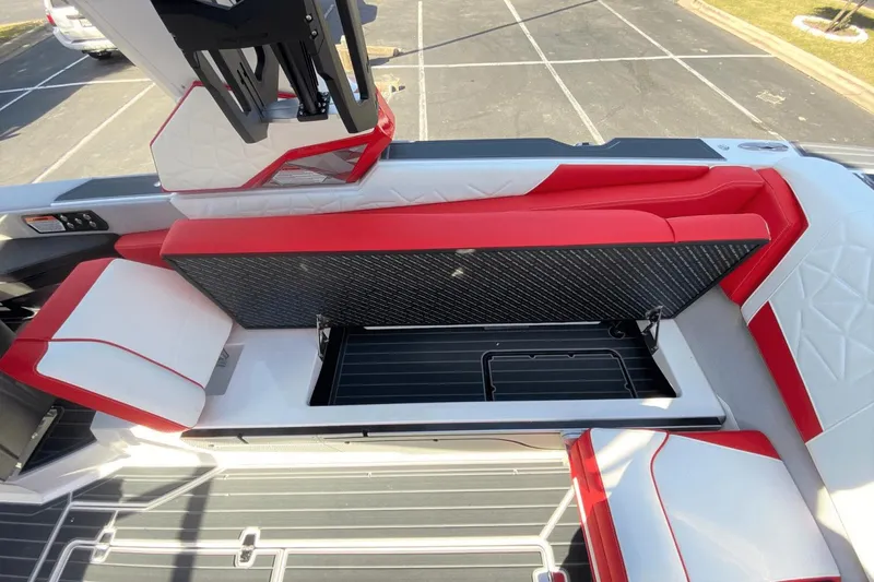 Slide: The Image of 2023 Nautique Super Air Nautique G25 Paragon interior with red and white seating and storage compartment. - 21