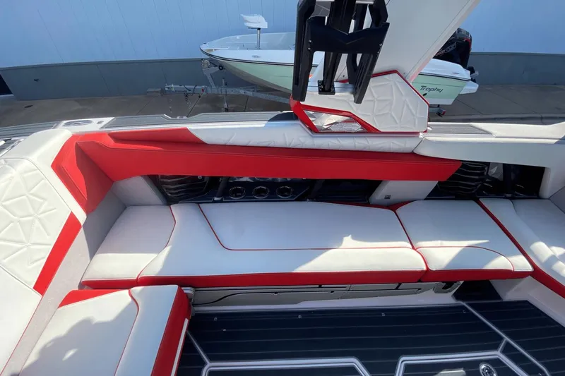 Slide: The Image of Interior seating of 2023 Nautique Super Air Nautique G25 Paragon boat with red and white upholstery. - 22