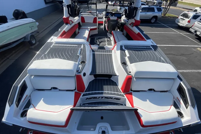 Slide: The Image of 2023 Nautique Super Air Nautique G25 Paragon boat interior with red and white seating. - 11