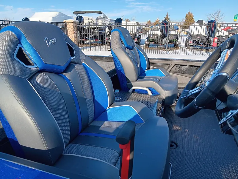 Slide: The Image of 2024 Ranger Z520R Ranger Cup Equipped boat interior with blue and gray seats. - 5