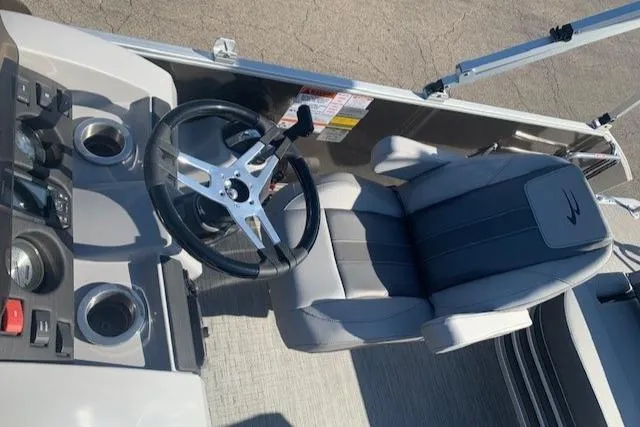 Slide: The Image of 2023 Bennington SX Line boat interior with steering wheel and captain's chair. - 13