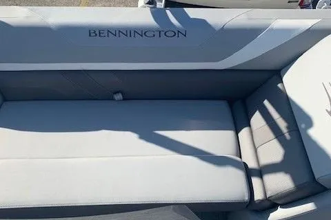 Slide: The Image of 2023 Bennington SX Line boat seating with gray upholstery and branding. - 16