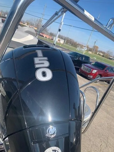 Slide: The Image of 2023 Bennington SX Line boat with 150 horsepower engine, parked outdoors. - 3