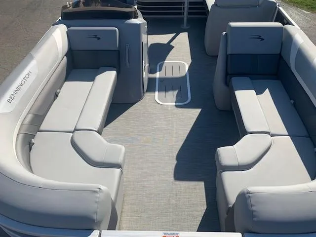 Slide: The Image of 2023 Bennington SX Line boat interior with gray seating and spacious layout. - 4