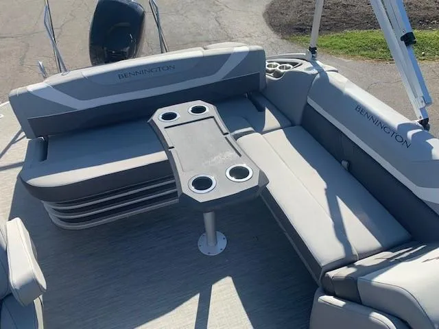 Slide: The Image of 2023 Bennington SX Line boat interior with gray seating and cup holders. - 5