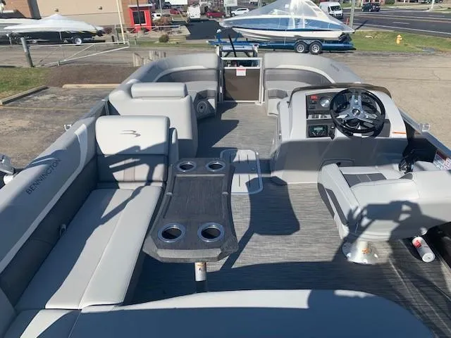 Slide: The Image of 2023 Bennington SX Line pontoon boat interior with seating and steering console. - 7