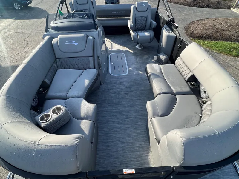 Slide: The Image of 2023 Bennington LX Sport Line pontoon boat with luxurious gray seating and spacious layout. - 1