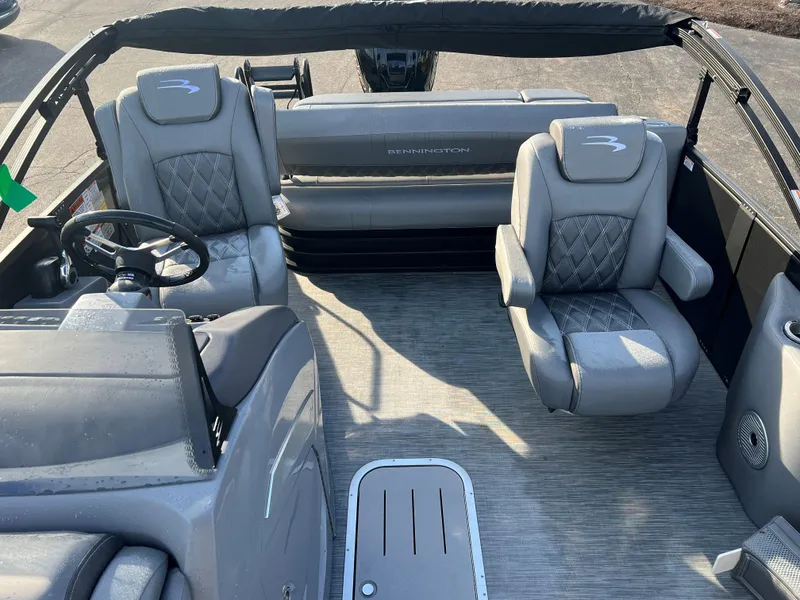 Slide: The Image of 2023 Bennington LX Sport Line boat interior with gray seating and steering wheel. - 2