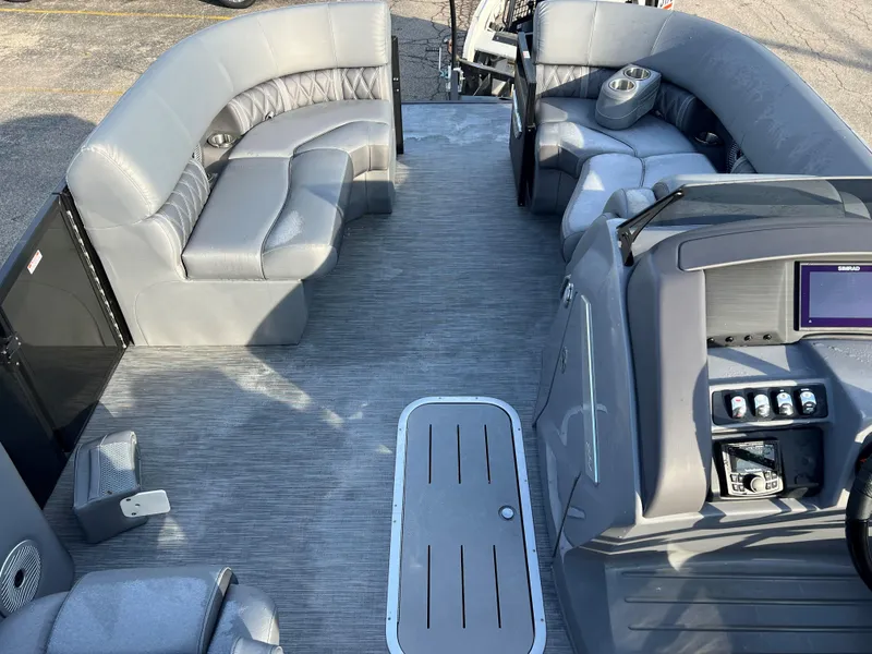 Slide: The Image of 2023 Bennington LX Sport Line boat interior with gray seating and modern dashboard. - 3
