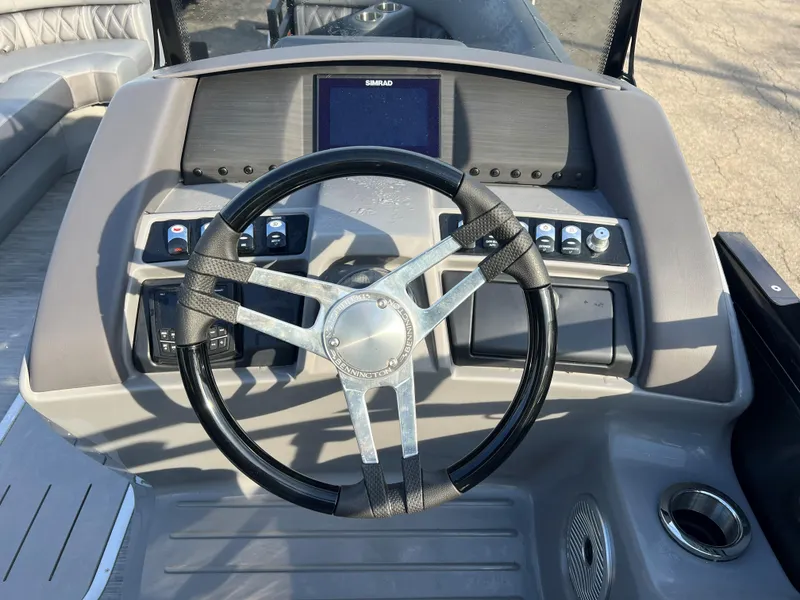 Slide: The Image of 2023 Bennington LX Sport Line boat dashboard with steering wheel and control panel. - 4