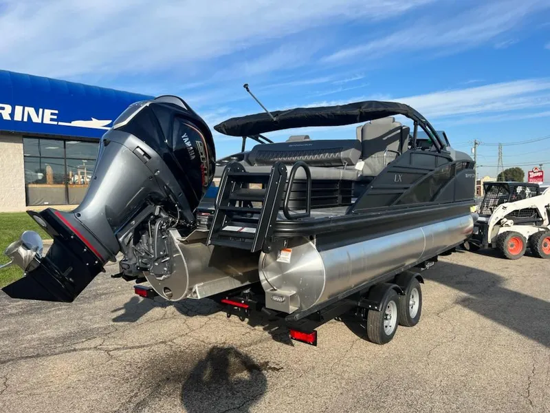 Slide: The Image of 2023 Bennington LX Sport Line pontoon boat on a trailer, featuring a powerful outboard motor. - 5