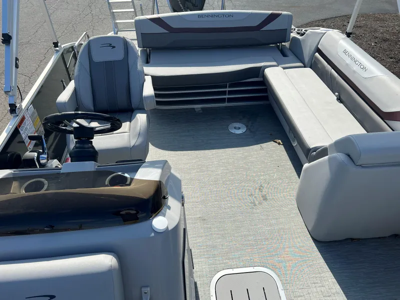 Slide: The Image of 2023 Bennington SX Line boat interior with seating and steering console. - 2