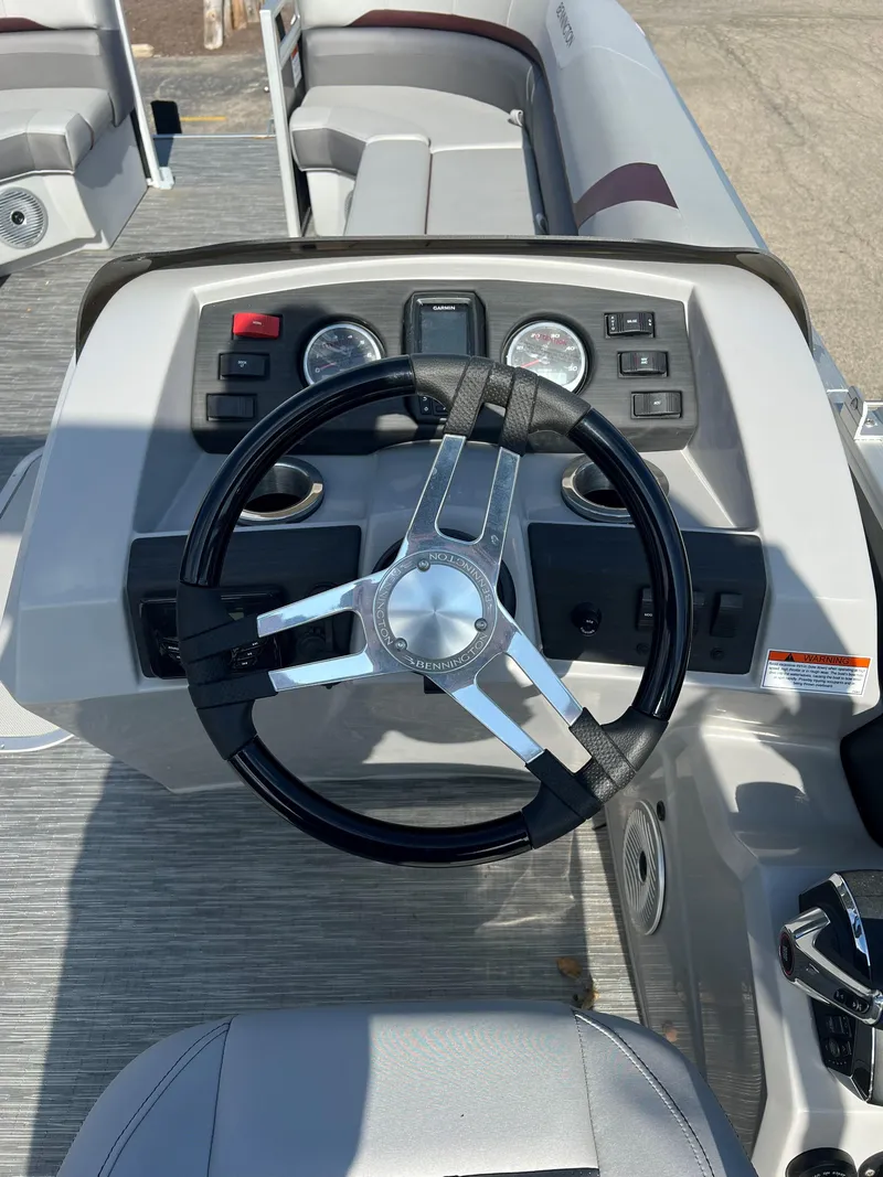 Slide: The Image of 2023 Bennington SX Line boat dashboard with steering wheel and control panel. - 5