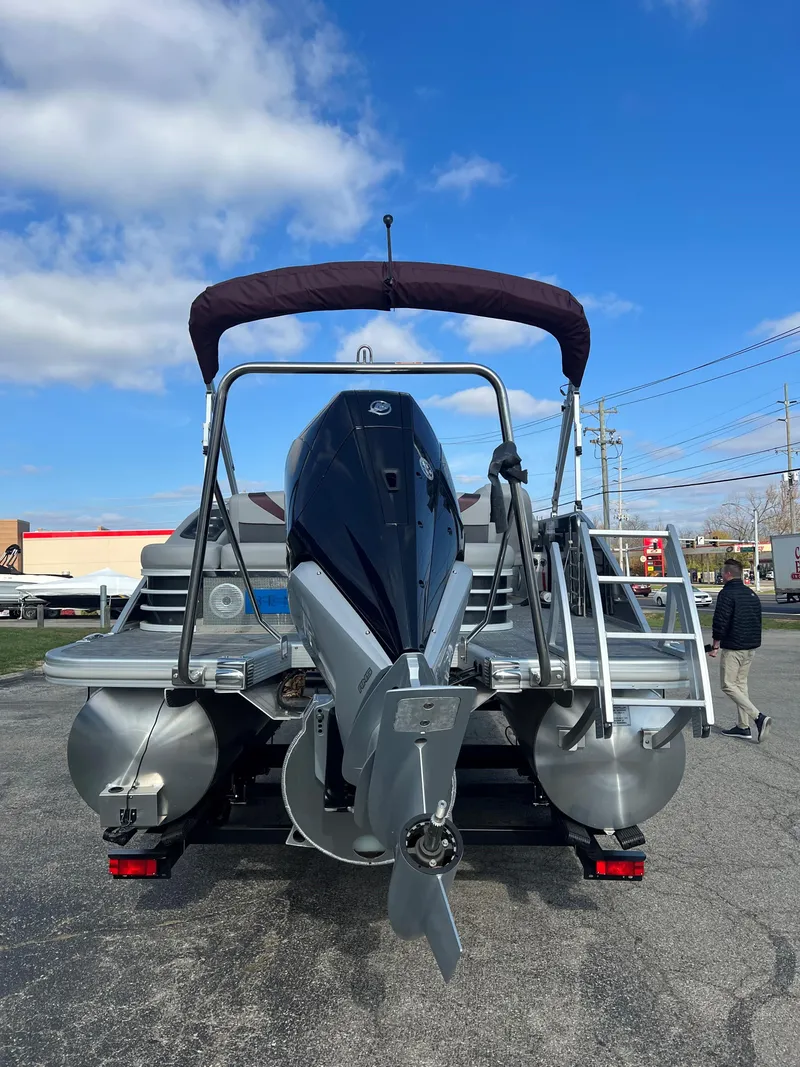 Slide: The Image of 2023 Bennington SX Line pontoon boat with outboard motor, rear view. - 7