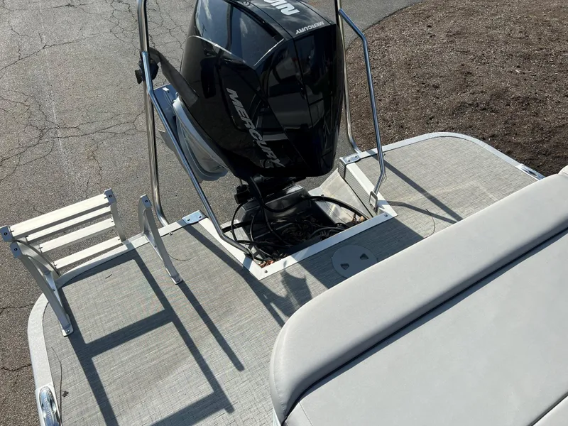 Slide: The Image of 2023 Bennington SX Line boat with Mercury outboard motor and swim ladder. - 8