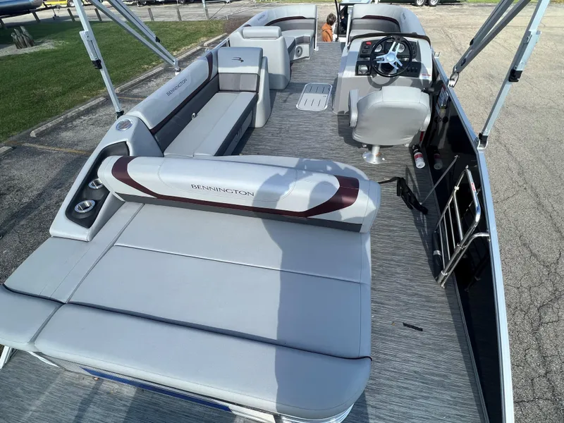 Slide: The Image of 2023 Bennington SX Line pontoon boat with spacious seating and modern interior design. - 9