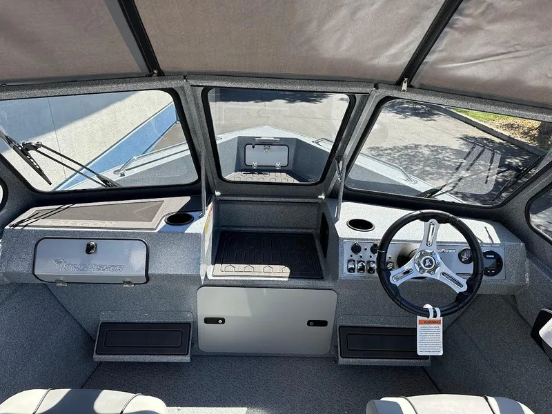 Slide: The Image of 2024 KingFisher 1825 Falcon boat interior with steering wheel and dashboard. - 14