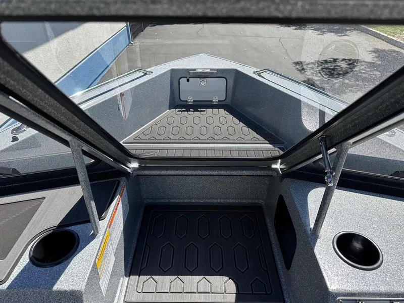 Slide: The Image of 2024 KingFisher 1825 Falcon boat interior with storage compartments and cup holders. - 15