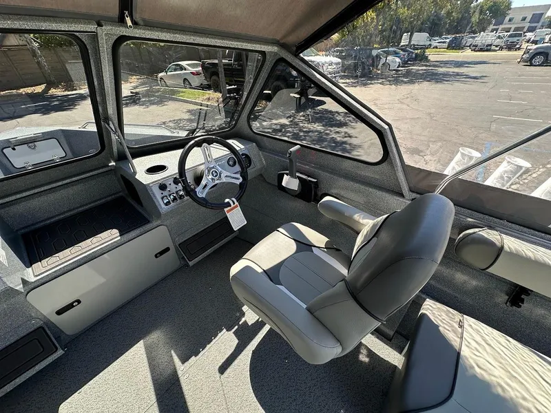 Slide: The Image of 2024 KingFisher 1825 Falcon boat interior with steering wheel and seating. - 16