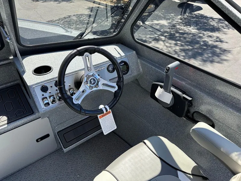 Slide: The Image of 2024 KingFisher 1825 Falcon boat interior with steering wheel and controls. - 17