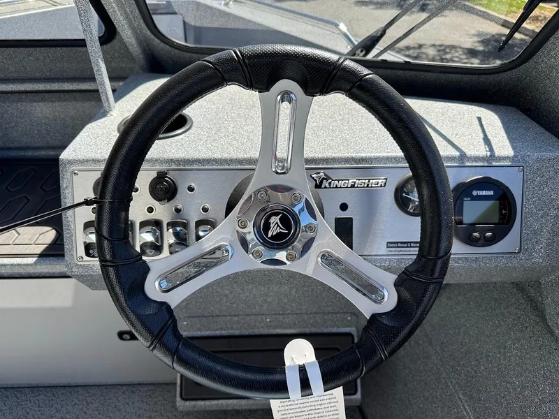 Slide: The Image of 2024 KingFisher 1825 Falcon boat steering wheel and dashboard controls. - 20